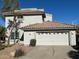 Two-story house with tile roof, attached garage, and desert landscaping at 9382 E Aster Dr, Scottsdale, AZ 85260