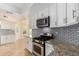 Modern kitchen with granite countertops, stainless steel appliances, and white cabinets at 9382 E Aster Dr, Scottsdale, AZ 85260