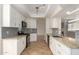 Updated kitchen with granite countertops and white cabinetry at 9382 E Aster Dr, Scottsdale, AZ 85260