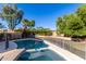 Sparkling pool with safety fence and surrounding landscaping at 9382 E Aster Dr, Scottsdale, AZ 85260