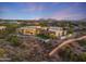 Luxury home with a pool and mountain views at dusk at 9940 E Aleka Way, Scottsdale, AZ 85262