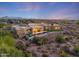 Luxury home with a pool and mountain views at dusk at 9940 E Aleka Way, Scottsdale, AZ 85262