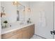 Modern bathroom with light wood vanity, white walls, and geometric floor tile at 9940 E Aleka Way, Scottsdale, AZ 85262