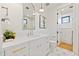 Stylish bathroom with white vanity, arched mirror, and geometric tile floor at 9940 E Aleka Way, Scottsdale, AZ 85262