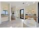 Elegant bathroom with a freestanding tub and marble vanity at 9940 E Aleka Way, Scottsdale, AZ 85262