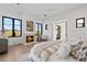 Spacious bedroom with a cozy fireplace, large windows, and a king-size bed at 9940 E Aleka Way, Scottsdale, AZ 85262