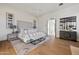 Bright bedroom with a plush bed, hardwood floors, and a view of the bathroom at 9940 E Aleka Way, Scottsdale, AZ 85262
