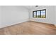 Bright bedroom with hardwood floors and large window offering scenic views at 9940 E Aleka Way, Scottsdale, AZ 85262