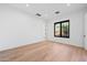 Bright bedroom with hardwood floors and large window at 9940 E Aleka Way, Scottsdale, AZ 85262