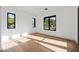 Light-filled bedroom with hardwood floors and multiple windows at 9940 E Aleka Way, Scottsdale, AZ 85262