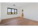 Spacious bedroom with hardwood floors, access to bathroom, and backyard view at 9940 E Aleka Way, Scottsdale, AZ 85262
