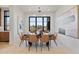 Bright dining room with a modern table and chairs, large windows, and contemporary art at 9940 E Aleka Way, Scottsdale, AZ 85262