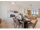 Open concept dining room with modern decor and a view into a stylish kitchen at 9940 E Aleka Way, Scottsdale, AZ 85262