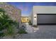 Elegant entryway with stone wall and landscaped walkway at 9940 E Aleka Way, Scottsdale, AZ 85262