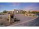 Modern home with a stone facade and paved driveway at 9940 E Aleka Way, Scottsdale, AZ 85262
