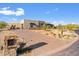 Modern home with a stone facade and paved driveway at 9940 E Aleka Way, Scottsdale, AZ 85262