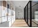 Long hallway with hardwood floors, large windows, and modern artwork at 9940 E Aleka Way, Scottsdale, AZ 85262