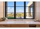 Kitchen features a farmhouse sink and views of the backyard at 9940 E Aleka Way, Scottsdale, AZ 85262