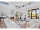 Spacious living area featuring a fireplace and abundant natural light at 9940 E Aleka Way, Scottsdale, AZ 85262