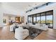 Open floor plan living room with kitchen views and large windows at 9940 E Aleka Way, Scottsdale, AZ 85262