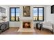 Relaxing living room with a fireplace, large windows showcasing scenic views, and comfortable seating at 9940 E Aleka Way, Scottsdale, AZ 85262