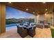 Covered patio with fireplace and mountain views at 9940 E Aleka Way, Scottsdale, AZ 85262