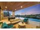 Stunning pool area at sunset with seating and scenic view at 9940 E Aleka Way, Scottsdale, AZ 85262