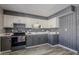 Modern kitchen with gray and white cabinets, and herringbone backsplash at 12846 N 113Th Ave # 4, Youngtown, AZ 85363