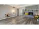 Living room featuring a gray brick fireplace and wood-look floors at 12846 N 113Th Ave # 4, Youngtown, AZ 85363