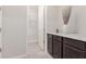 Small bathroom with dark brown cabinets and grey floor at 19606 W Grant St, Buckeye, AZ 85326