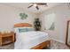 Cozy bedroom with wood frame bed and ceiling fan at 19606 W Grant St, Buckeye, AZ 85326