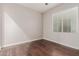 Simple bedroom with dark wood floors and ceiling fan at 19606 W Grant St, Buckeye, AZ 85326