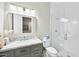 Modern bathroom with gray vanity, marble countertop, and glass shower at 2335 E Plum St, Gilbert, AZ 85298