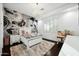 Bright bedroom with a comfy bed, built-in desk, and stylish wall mural at 2335 E Plum St, Gilbert, AZ 85298