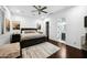 Main bedroom with dark wood furniture, a ceiling fan, and an ensuite bathroom at 2335 E Plum St, Gilbert, AZ 85298