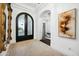 Elegant entryway with arched doorway, decorative mirror, and neutral color palette at 2335 E Plum St, Gilbert, AZ 85298