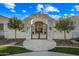 Stone archway and iron gate create an elegant entry to the home at 2335 E Plum St, Gilbert, AZ 85298