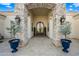 Grand entry with decorative iron door and stone pillars at 2335 E Plum St, Gilbert, AZ 85298