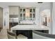 Kitchen island with beverage center and glass-front cabinets at 2335 E Plum St, Gilbert, AZ 85298