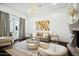 Bright living room featuring a cozy seating area and a statement chandelier at 2335 E Plum St, Gilbert, AZ 85298