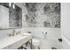Modern powder room with a marble vanity and cloud-patterned wallpaper at 2335 E Plum St, Gilbert, AZ 85298
