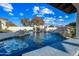 Stunning pool with a rock waterfall and a spacious deck at 2335 E Plum St, Gilbert, AZ 85298