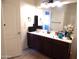 Bathroom with dark wood vanity and a large mirror at 25422 W Maldonado Ct, Buckeye, AZ 85326