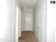 Hallway with neutral colored carpet and doors to bedrooms at 25422 W Maldonado Ct, Buckeye, AZ 85326
