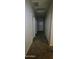 Long hallway with carpeted floors and access to bedrooms at 25422 W Maldonado Ct, Buckeye, AZ 85326
