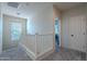 Upstairs hallway with white railing and carpeted floors at 3821 E Branham Ln, Phoenix, AZ 85042