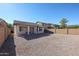 Large backyard with gravel and a covered patio at 41208 W Bravo Dr, Maricopa, AZ 85138