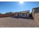 Spacious backyard with gravel and a covered patio at 41208 W Bravo Dr, Maricopa, AZ 85138