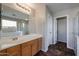 Bathroom with double vanity, large mirror, and tile flooring at 41208 W Bravo Dr, Maricopa, AZ 85138