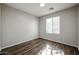 Simple bedroom with wood-look flooring and window at 41208 W Bravo Dr, Maricopa, AZ 85138